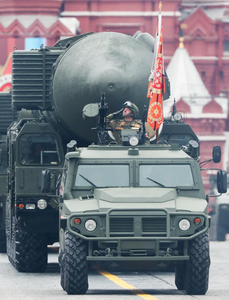  A military vehicle rolls through the square followed by a massive nuclear warhead