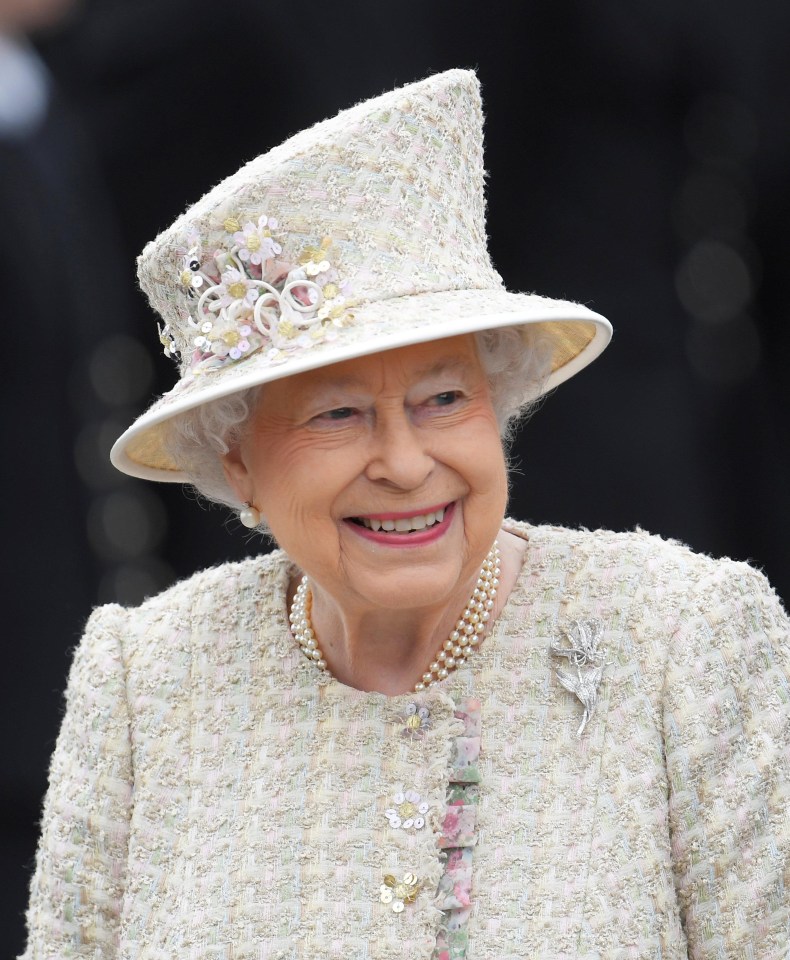 Her Majesty wore a pastel tweed dress and coat in shades of pale pink for the occasion