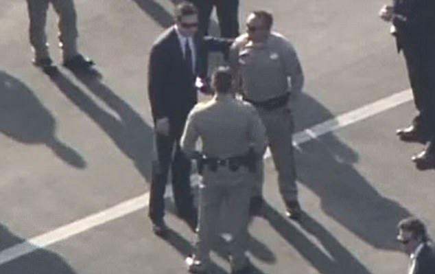  James Comey, left, speaks to police officers in LA just after he learned Trump had dismissed him as head of the FBI