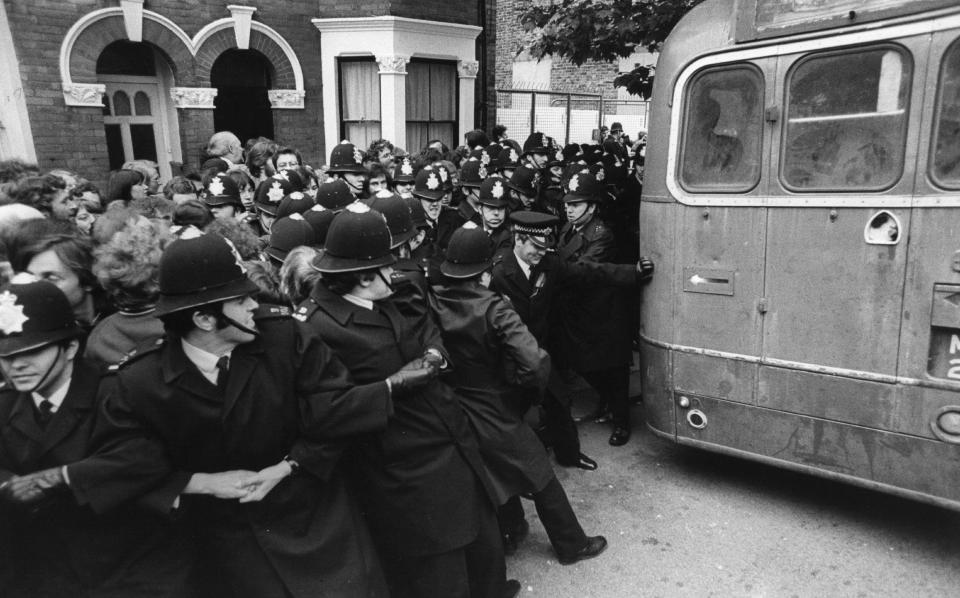  Dozens of police officers hold back feuding protesters at the Grunwick dispute