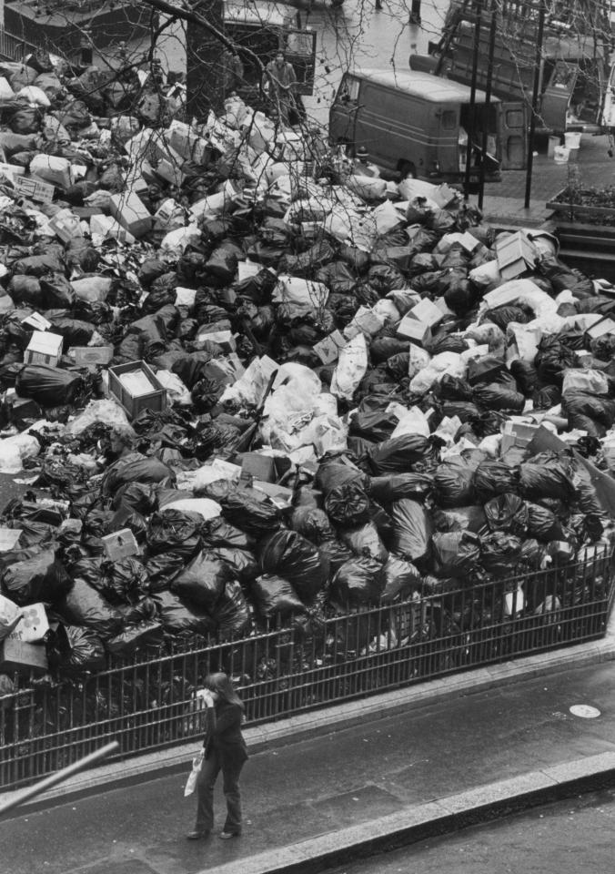  A passer-by holds her nose as she walks past the growing pile of uncollected rubbish in Leicester Square, after it was designated a Council Refuse Centre during the strike in 1979