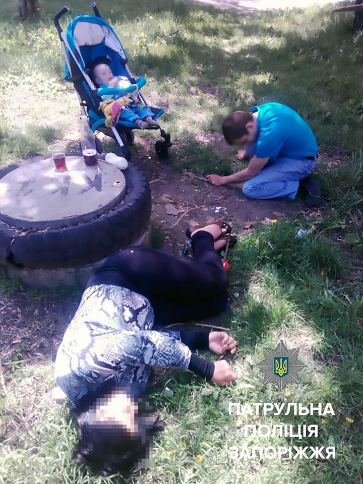 A photo showing the couple passed out in a park earlier the same day