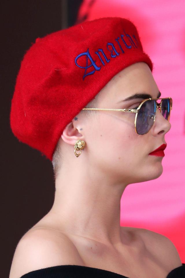  She covered her shaved head with a bright red beret