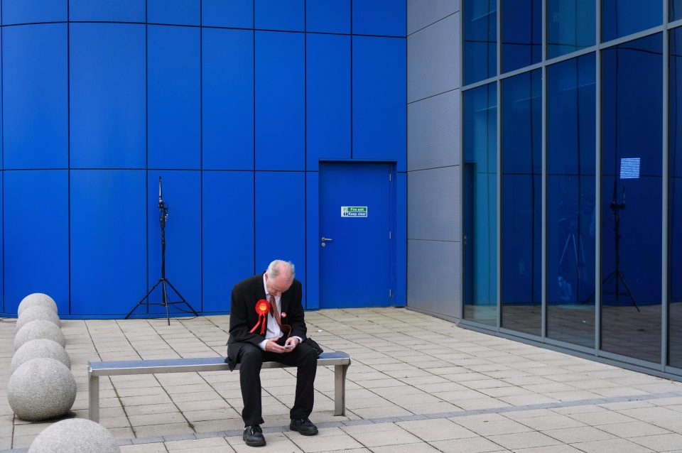 A Labour supporter cuts a lonely figure outside a party event in Peterborough 