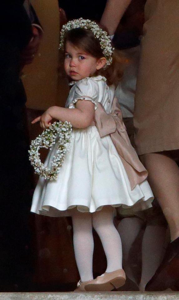  Charlotte was wearing a pretty white bridesmaid dress with pale pink bow, the bespoke outfit was designed by Pepa & Co