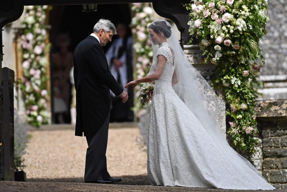  Pippa reaches for her dad's hand as he is about to give her away to beau James