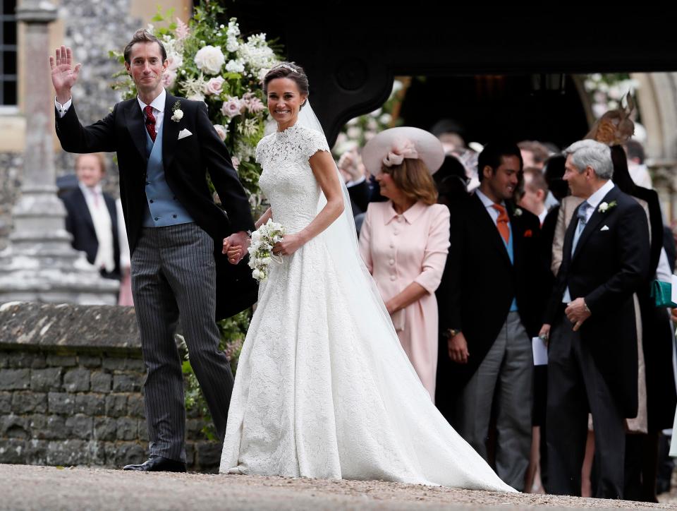  Wedded bliss... James Matthews holds hands with new wife Pippa as they greet crowds outside St Mark's Church in Berkshire