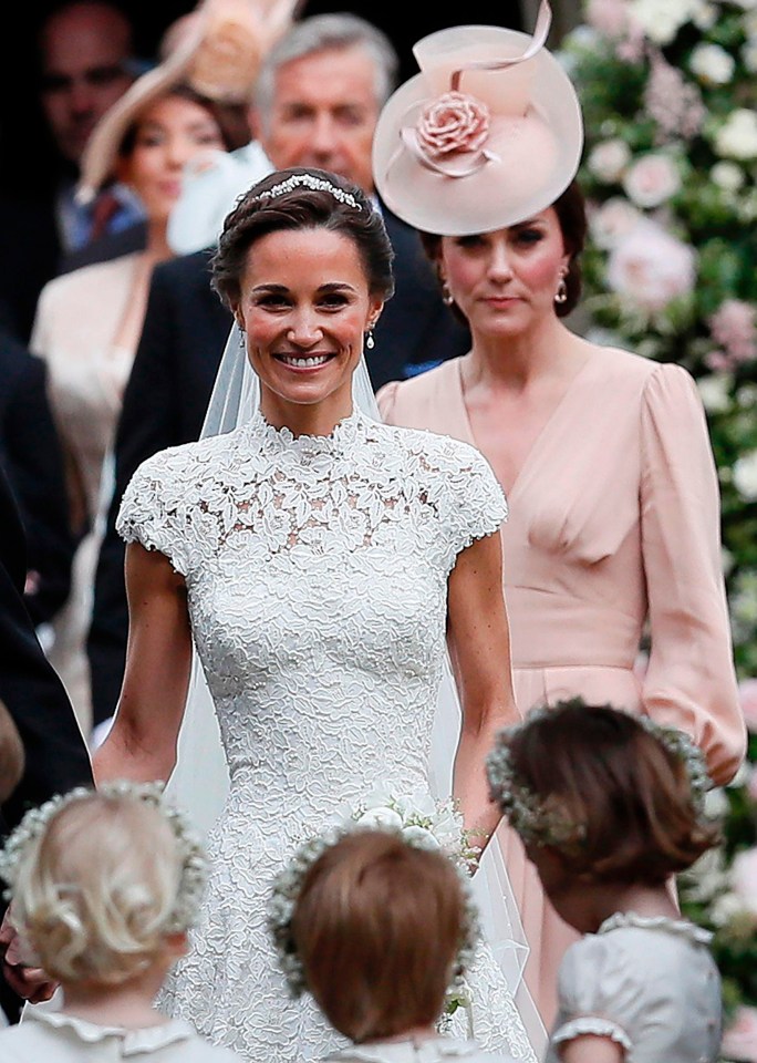 Pippa was all smiles as she walked out of the church yesterday, flanked by her proud sister Kate, who was dressed in a bespoke peach outfit by designer Alexander McQueen