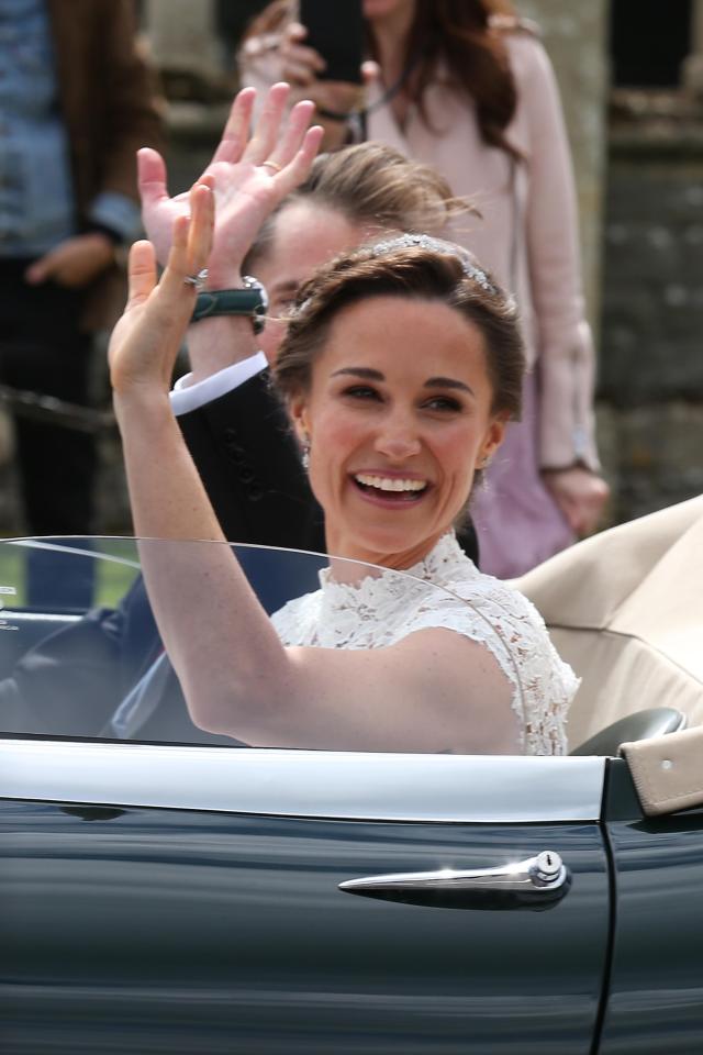  Pippa beams as she waves from open top car on way to wedding reception