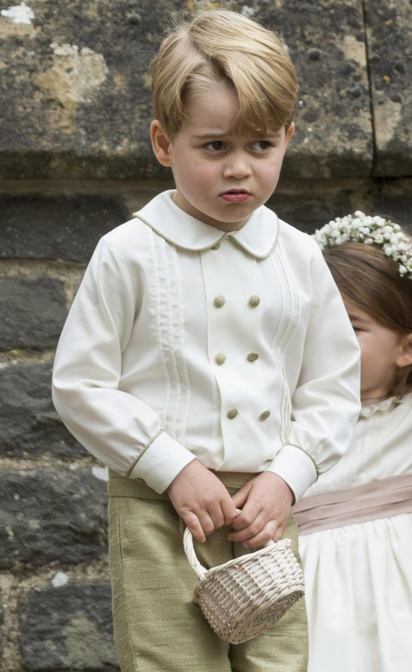 Prince George was spotted looking very unimpressed after receiving a telling off from his mum Kate outside of the church