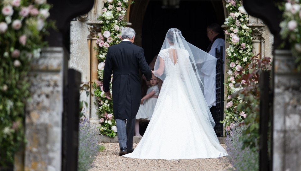 Giles’ spectacular dress for Pippa Middleton featured cap sleeves and an elegant high neckline. She also wore a glittering tiara and Manolo Blahnik heels