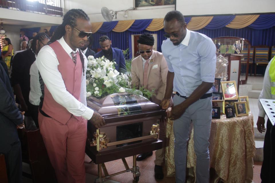  Usain Bolt was a pallbearer as he helped carry Germaine Mason's coffin in Kingston