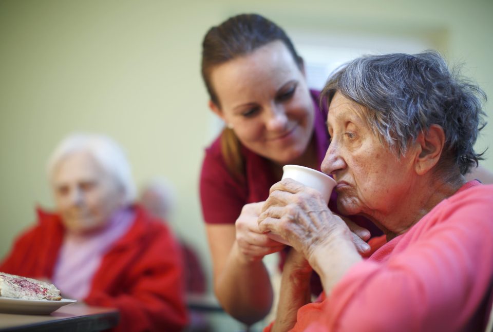 Elderly person drinking some water 