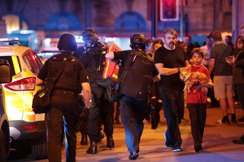 Armed police at the scene in Manchester where thousands have fled a concert