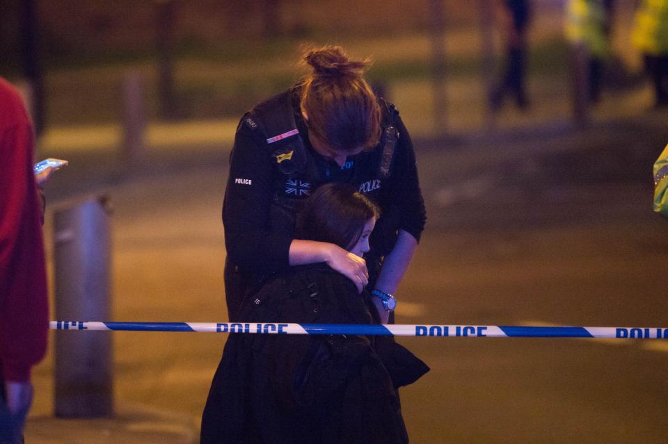 One little girl was seen being comforted by a female police officer