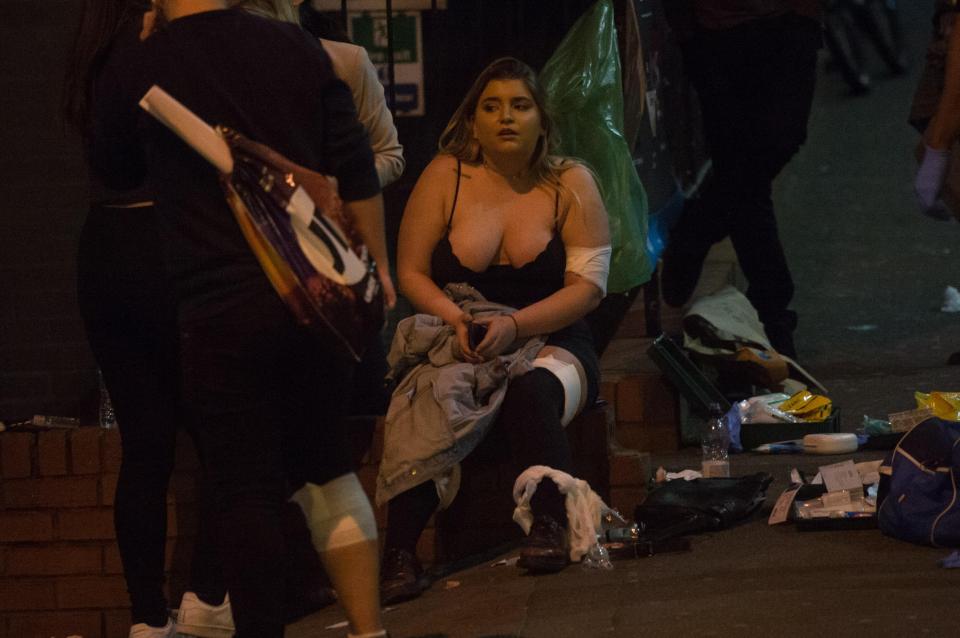  In shock . . . girl sits amid the chaos outside arena