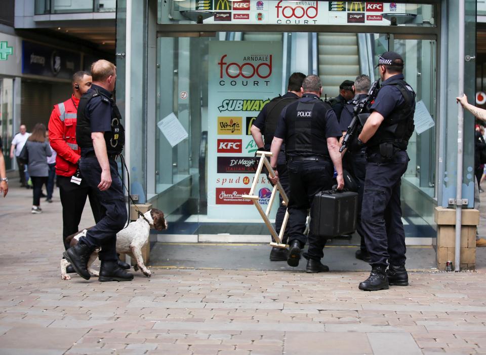 Armed cops with sniffer dogs close off the street