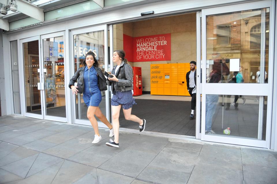 People were pictured running from the shopping centre today 