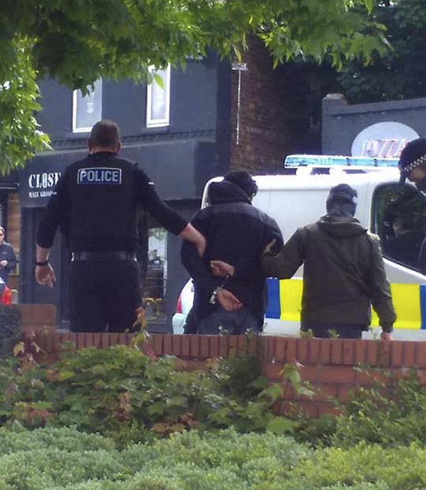 A man can be seen being led away from the scene in south Manchester