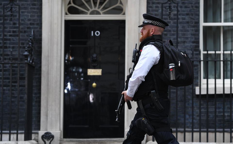  An armed police officer walks in front of No. 10 Downing Street in London