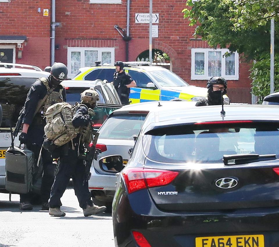 Armed police were at the scene of the raid as officials race to determine if Salman Abedi was part of a terror cell