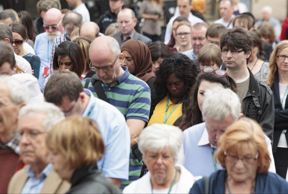 Mourners bow their heads in sadness at the event in Peterborough