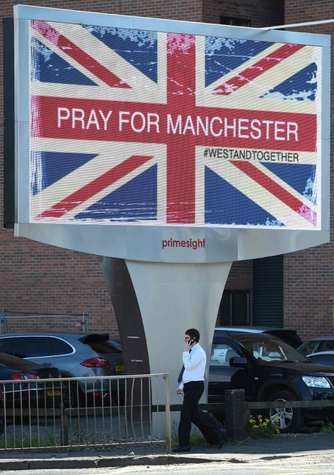 Another electronic advertising board displays a defiant flag, with the hashtag #westandtogether