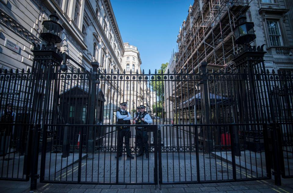  Police outside Downing Street in London, after Scotland Yard announced armed troops will be deployed to guard 'key locations'