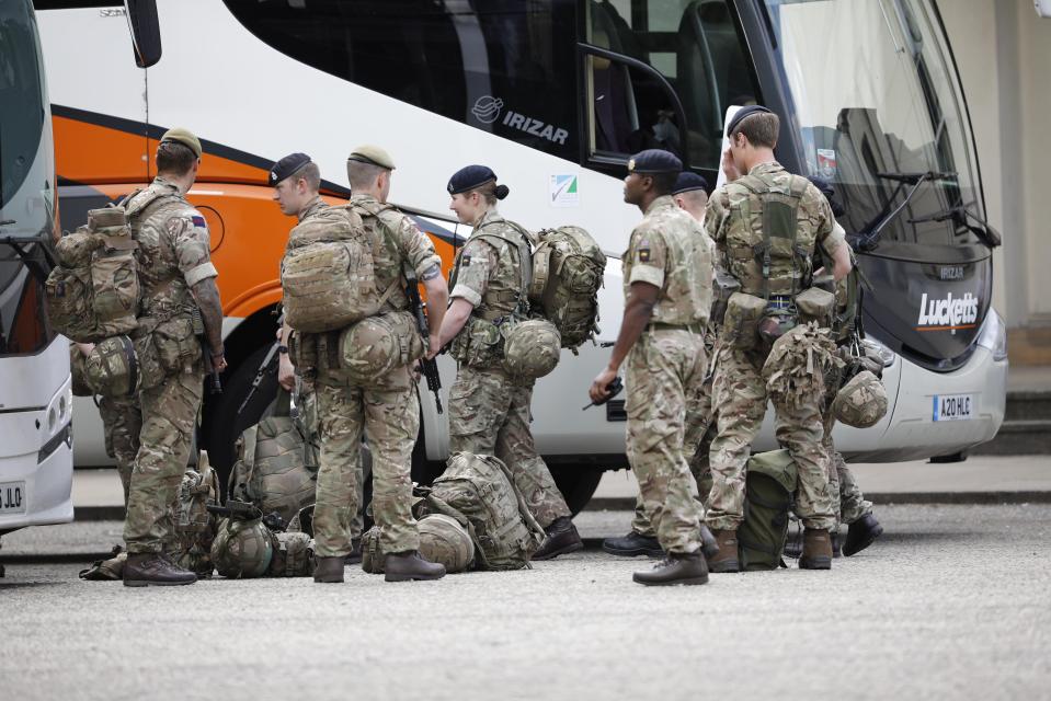  Soldiers are seen lining up to get on coaches at Wellington barracks