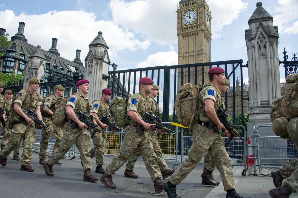  Troops pictured marching into Parliament while carrying guns this afternoon