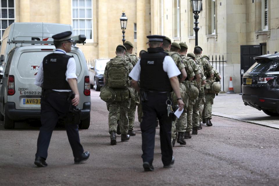  Troops arrive at Buckingham Palace as soldiers join forces with armed police