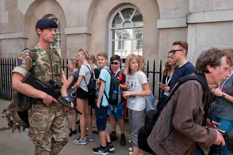  British Army soldiers patrol along Whitehall near Downing Street and the Houses of Parliament in central London