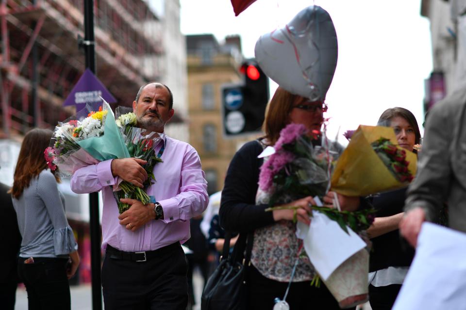  Manchester City Council workers move balloons and flowers to St Ann's Square from Albert Square