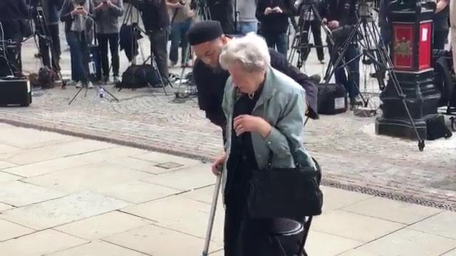  Sadiq helps 93-year-old Renee to her feet in a touching show of unity