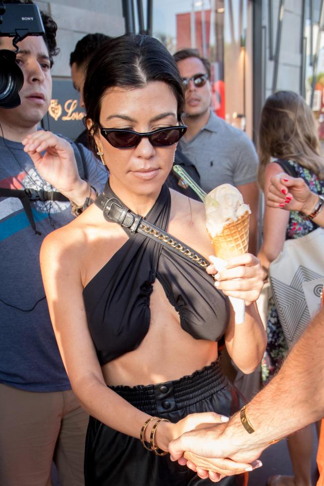  Kourtney Kardashian enjoyed a large scoop of ice cream as she and sister Kendall hit a parlour in Cannes today.