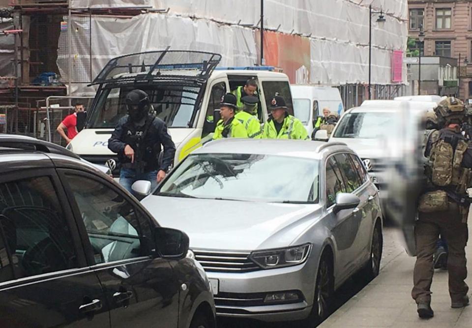 Armed police outside Granby House in Granby Row, Manchester