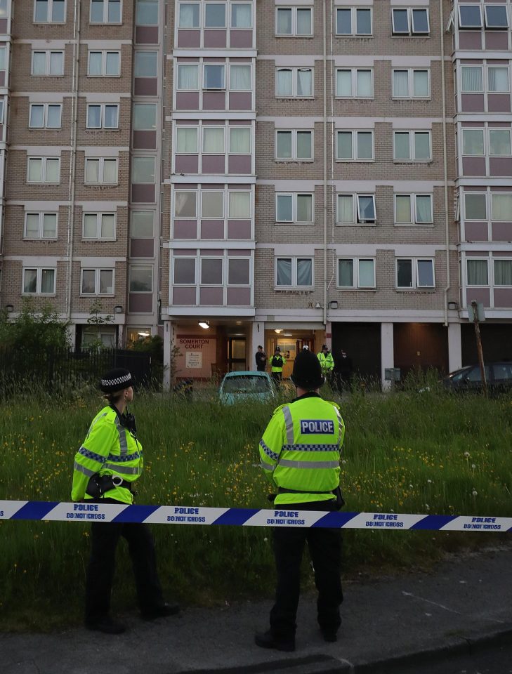  Police stand outside a block of flats in Blackley, Greater Manchester, where a woman was arrested before being released