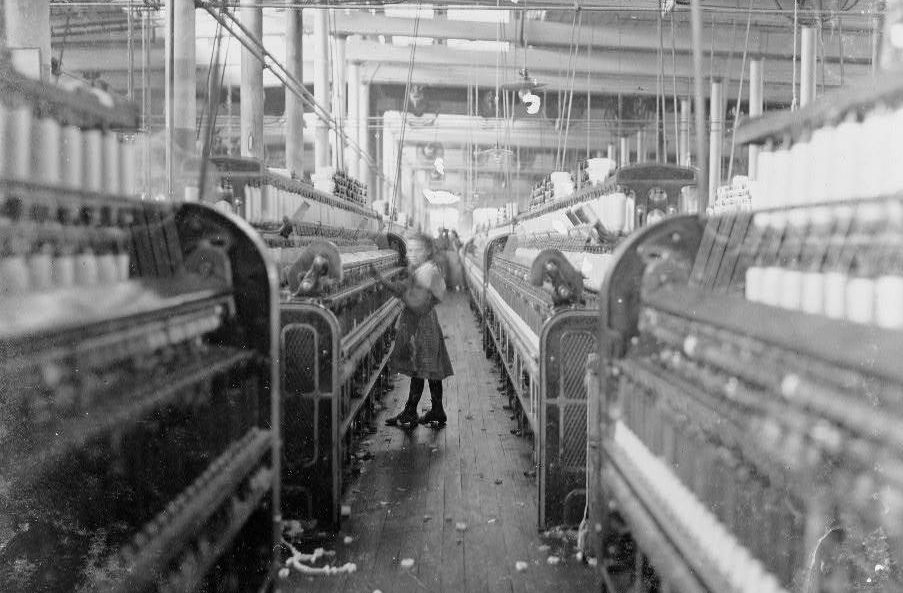  A little spinner gets close to the dangerous machines in the Mollahan Cotton Mills, Newberry in 1908