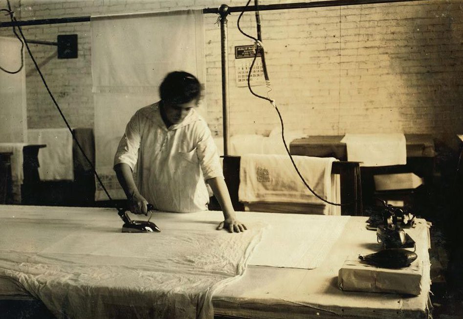  Sadie McGurin, aged 15 years old, is shown pressing curtains at Boutwell, Fairclough & Gold, 274 Summer Street Extension in Massachusetts in 1917