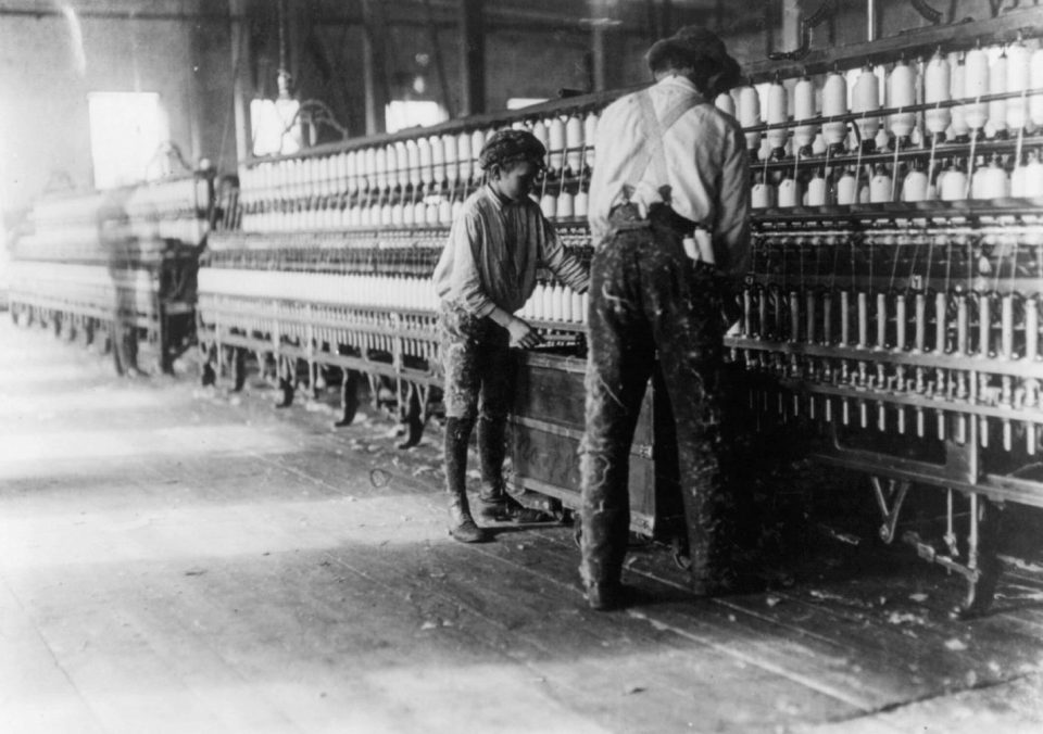  Small kids assist adults in the Vivian Cotton Mills, Cherryville, N.C, in 1908, and sometimes weren't compensated for their time