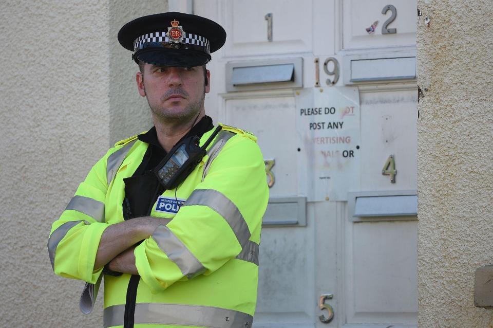  A police officer stands on duty outside a residential property on Egerton Crescent in Withington, Manchester