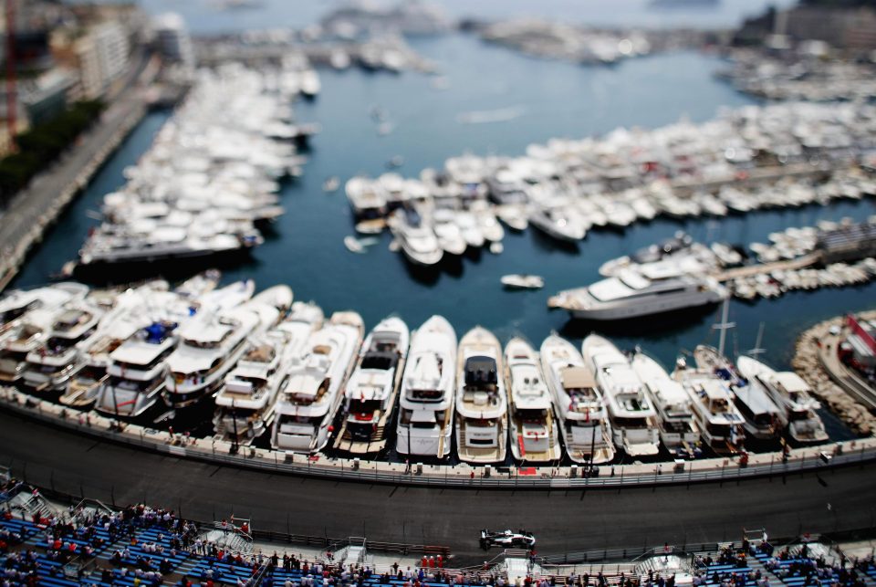  Lewis Hamilton speeds past the superyachts in the harbour