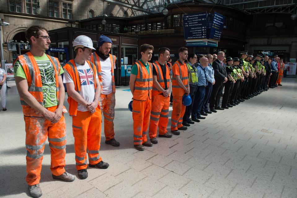  Workmen stood shoulder to shoulder with staff and police officers during the silence at Glasgow Central Station