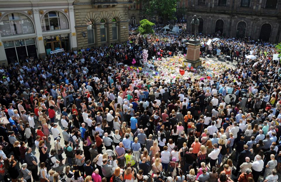  People attend a one-minute silence for the victims of Monday's explosion at St Ann's Square in Manchester