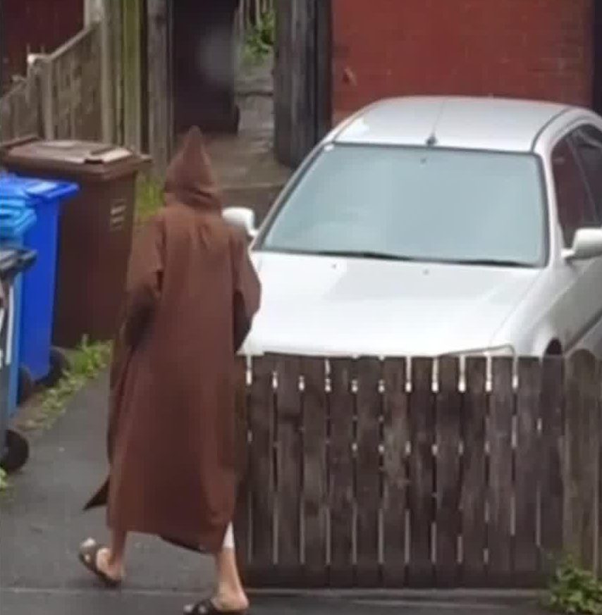  He walks back towards his home after wheeling the bins out to the pavement