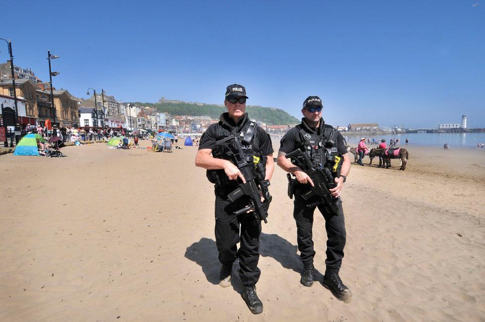  Armed police pictured patrolling British beaches amid terror alert across the UK