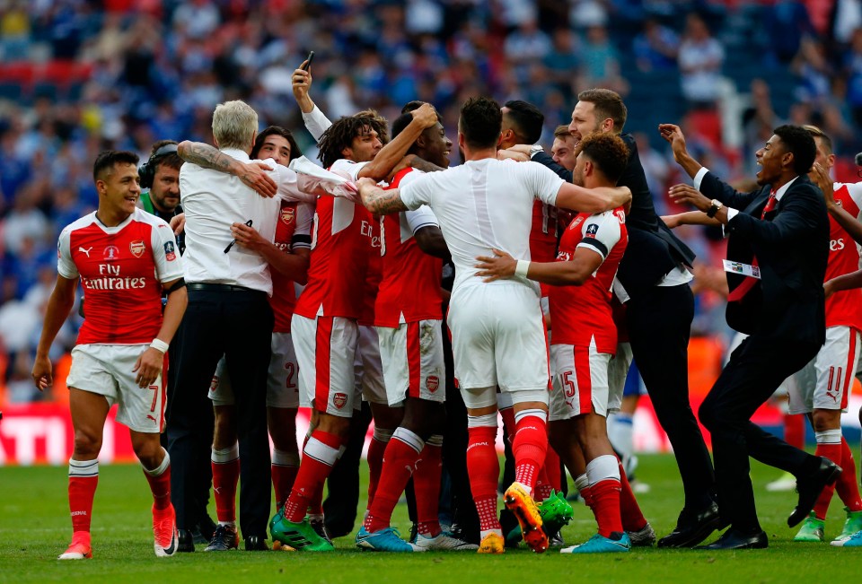 The jubilant Arsenal squad celebrate their triumph with manager Arsene Wenger