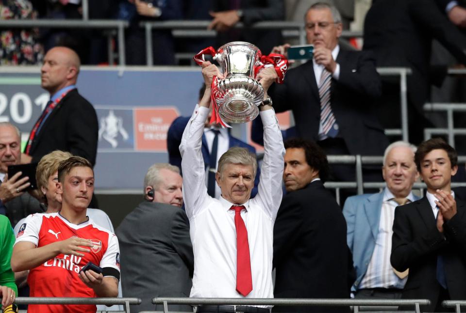  Arsene Wenger lifts the FA Cup aloft for a record seventh time