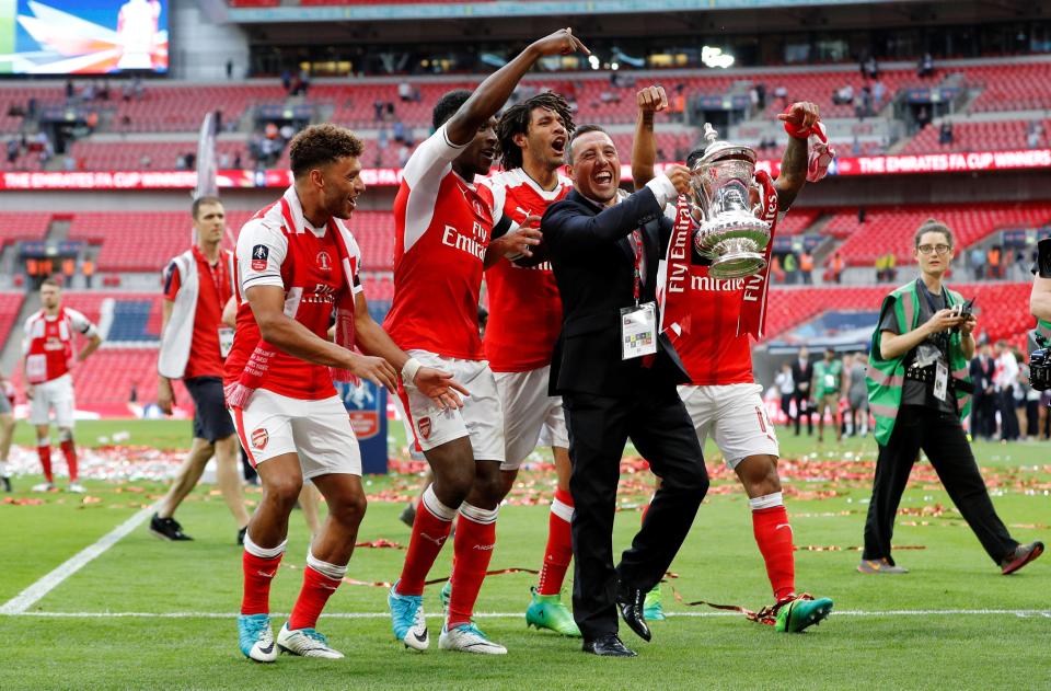 Arsenal's Santi Cazorla celebrates with the trophy and his team-mates after winning the FA Cup final