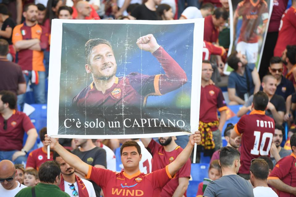 A Roma fan holds placard with Francesco Totti's picture and words: "There's only one captain"